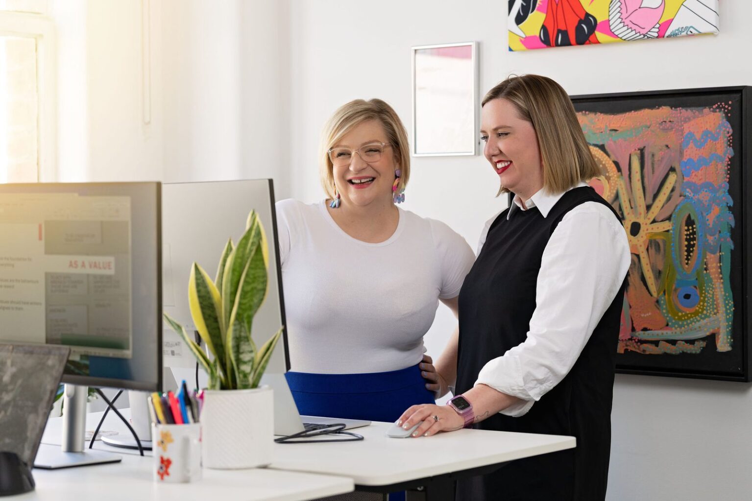 Alison and Kayla working together at a desk